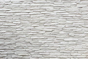 Surface white wall of stone wall gray tones for use as background.