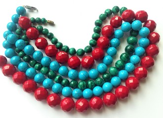 Women's jewelry beads made of coral, malachite and turquoise. Beautiful beads made of natural stones.