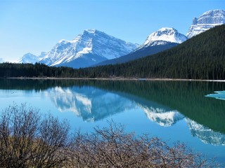 Snowcapped mountains reflected on a lake in the mountains