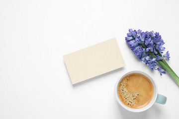 Blank card, coffee and hyacinth flowers on white background, top view. Good morning