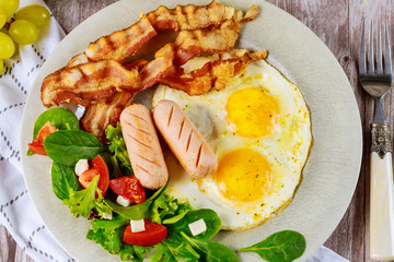Franks, fried eggs, bacon and salad for breakfast.