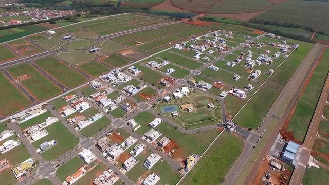 Aerial drone view of a city with houses and mansions being built