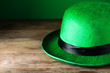 Green leprechaun hat on wooden table, closeup. St. Patrick's Day celebration