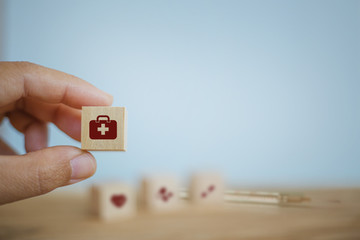 Medical treatment / Medical operating system / Healthcare concept : Hand chooses wooden cube blocks...