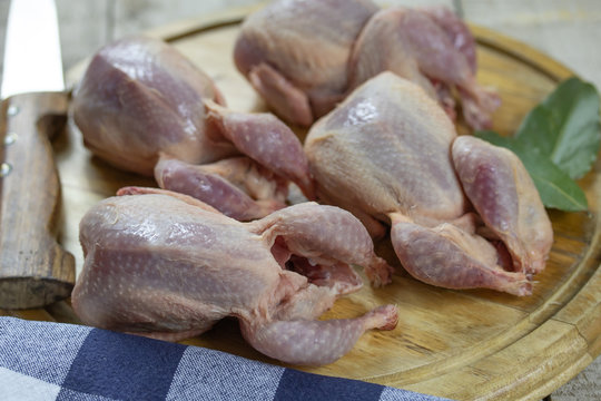 cailles crues sur une planche &agrave; d&eacute;couper