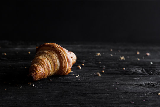 Close Up Of Chocolate Croissant On Dark Wooden Surface