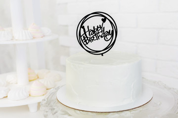 white birthday cake with tittle 'Happy birthday'
