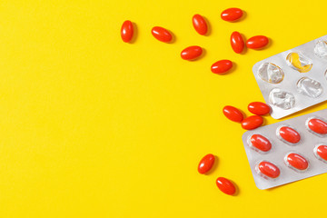 red pills on yellow  background