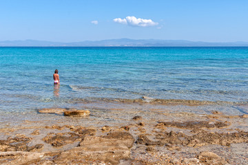 Girl entering water, Halkidiki, Greece