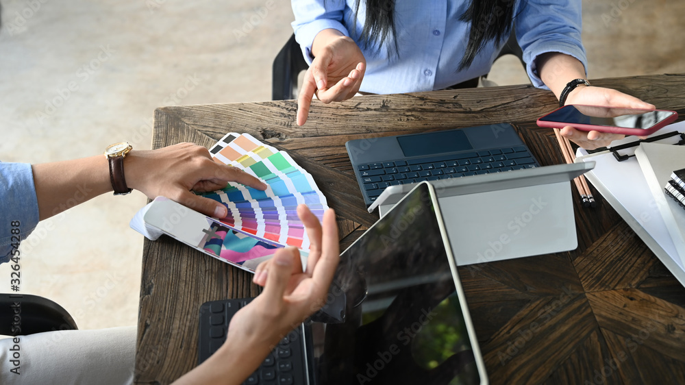 Aufkleber cropped image of business development team working/meeting at the modern wooden table with white bla