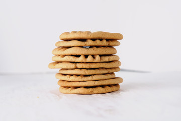 Stack of peanut butter cookies close up isolated on white background, dessert food.