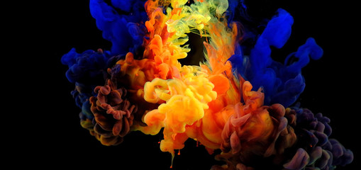 Obraz premium Color drops in water , abstract color mix , drop of Ink color mix paint falling on water Colorful ink in water,