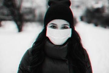 sick girl in a medical mask to protect against the virus and flu epidemic in the winter