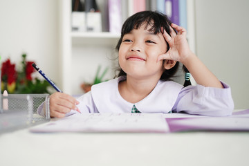 Happy genuis student kid girl enjoy learning at school. Intelligence,Hoework, studying and Education concept.