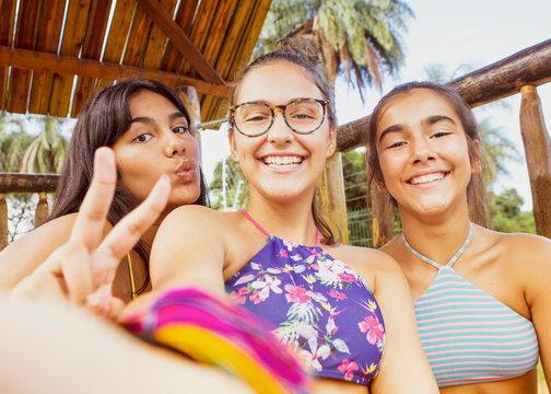  A Selfie Of Three Young Girl Friends, Smiling While Looking At The Camera. 