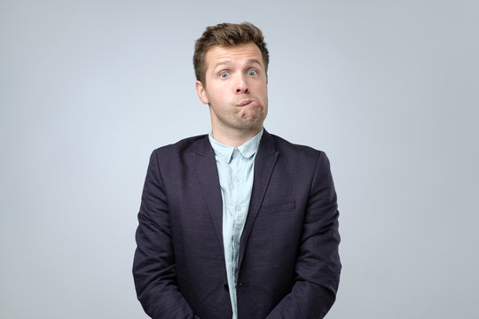 Confused Young Man In Suit Is Confused Feeling Stressed. Guy Made A Mistake.