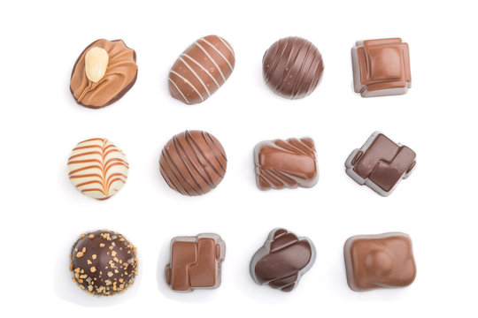 Different chocolate candies isolated on white background. top view, close up.