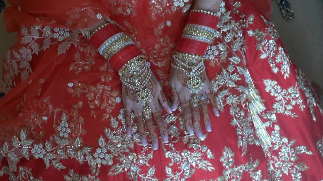 Indian Bride hands with intricate henna design, bangles and jewelry, Zoom Out