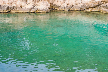 Beautiful wild beach with turquoise water and rocky cliffs in Calanques National Park.