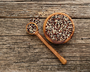 Quinoa in wooden spoon  on wooden background.