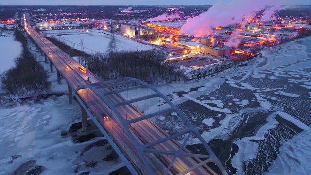 Scenic highway bridge predawn, dynamic aerial view with city lights and traffic. This is the Leo Frigo Memorial Bridge, Green Bay, Wisconsin.