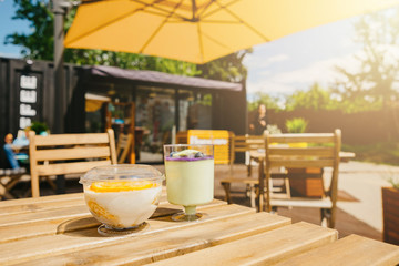 Mini desserts snacks in plastic cups. On the table