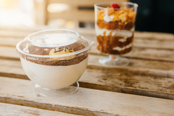 Mini desserts snacks in plastic cups. On the table