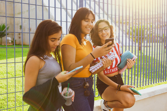 Group of  young happy friends having fun in front the school 