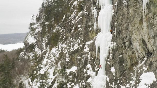 Astonishing scenic aerial climbers scale frozen cascade Mount Kineo, Maineline 