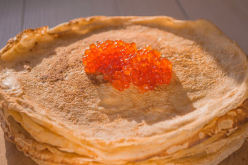 Stack of Russian pancakes with red caviar. Shrovetide Concept.