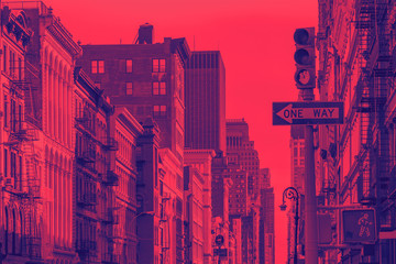 Buildings of SoHo in New York City with vibrant red and purple duotone effect - obrazy, fototapety, plakaty
