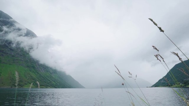 Fjord fills up with mist like clouds before  summer storm comes -timelaps from urke in Norway