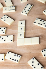 Dominoes. Old domino bones lay on a wooden brown table