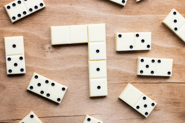 Dominoes. Old domino bones lay on a wooden brown table