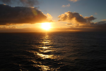 Fototapeta na wymiar Sonnenuntergang zwischen Wolken und Meer