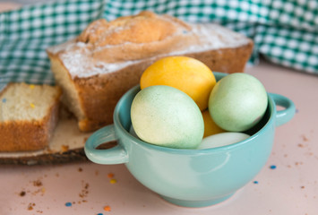 green and yellow Easter eggs in a plate, cake,