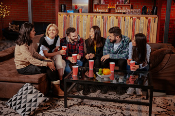 Group of multiethnic students very attractive and charismatic in a modern college library have a friendly atmosphere socializing enjoying the time