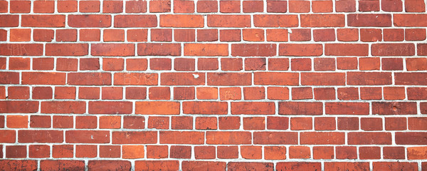 Red color brick wall for brickwork background design. Panorama format.