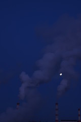 Fototapeta na wymiar Smoke from factory chimneys in the sky under the moon