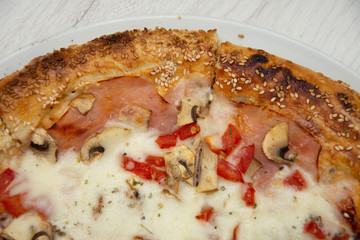 pizza with peppers and mushrooms, sesame and olives