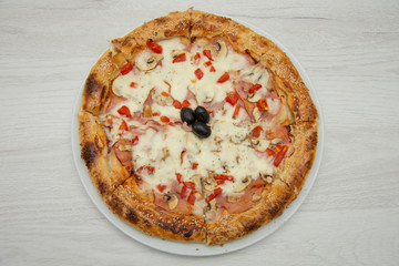 pizza with peppers and mushrooms, sesame and olives