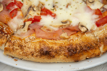 pizza with peppers and mushrooms, sesame and olives