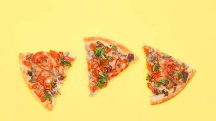 Three slices of pizza on a yellow background