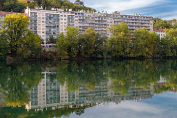 Reflections of the city across the river in Lyon, France