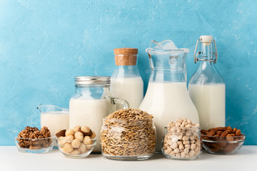 Different types of lactose-free vegetarian dairy products. Milk from macadamia, chickpeas, oats,...