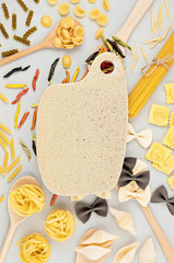 Flat lay with different types of traditional italian pasta. Penne, tagliatelle, fusilli, farfalle, spaghetti and others. Traditional italian cusine concept. Top view