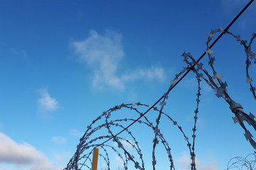 barbed wire against the blue sky