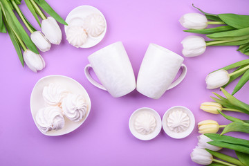 Fototapeta na wymiar white tulips and white mug with tea, sweets on pink background. Flat lay. Valentine's day, Mother's day, international women day