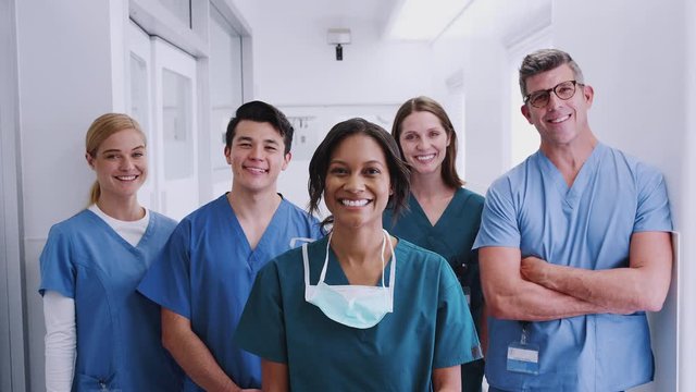 Portrait Of Smiling Multi-Cultural Medical Team Standing In Hospital Corridor 