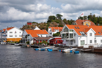 Fototapeta na wymiar White houses on the seafront in Mandal city, Southern Norway